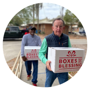 Volunteers Amos Robinson and Jim Longmire deliver "Boxes of Blessing" for families experiencing food insecurity.